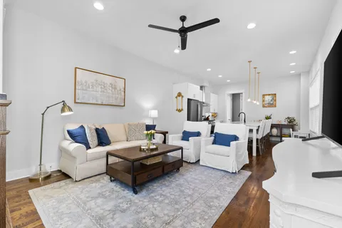 a living room with furniture and kitchen view