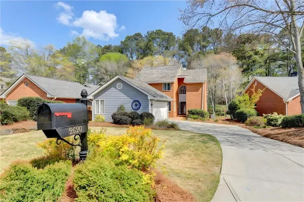a view of a house with pool and sitting area