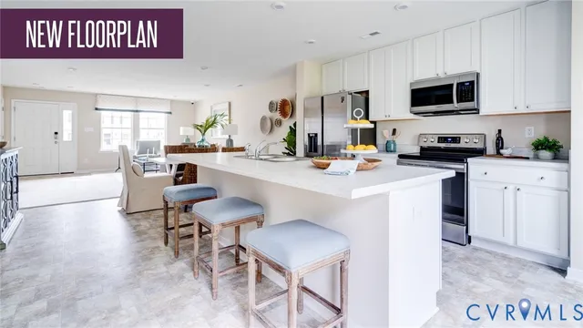 a kitchen with stainless steel appliances kitchen island granite countertop a stove a sink a microwave a dining table and chairs