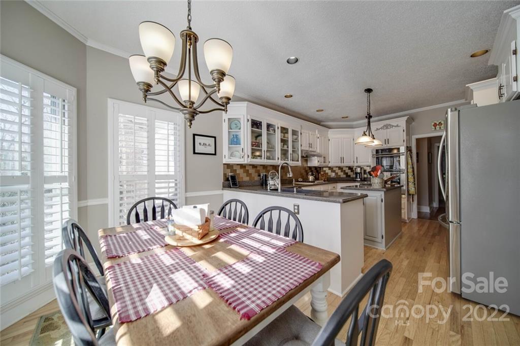 2700 Dutch Road Mount Pleasant, NC 28124 - Photo 17 of 48 a kitchen with sink refrigerator dining table and chairs