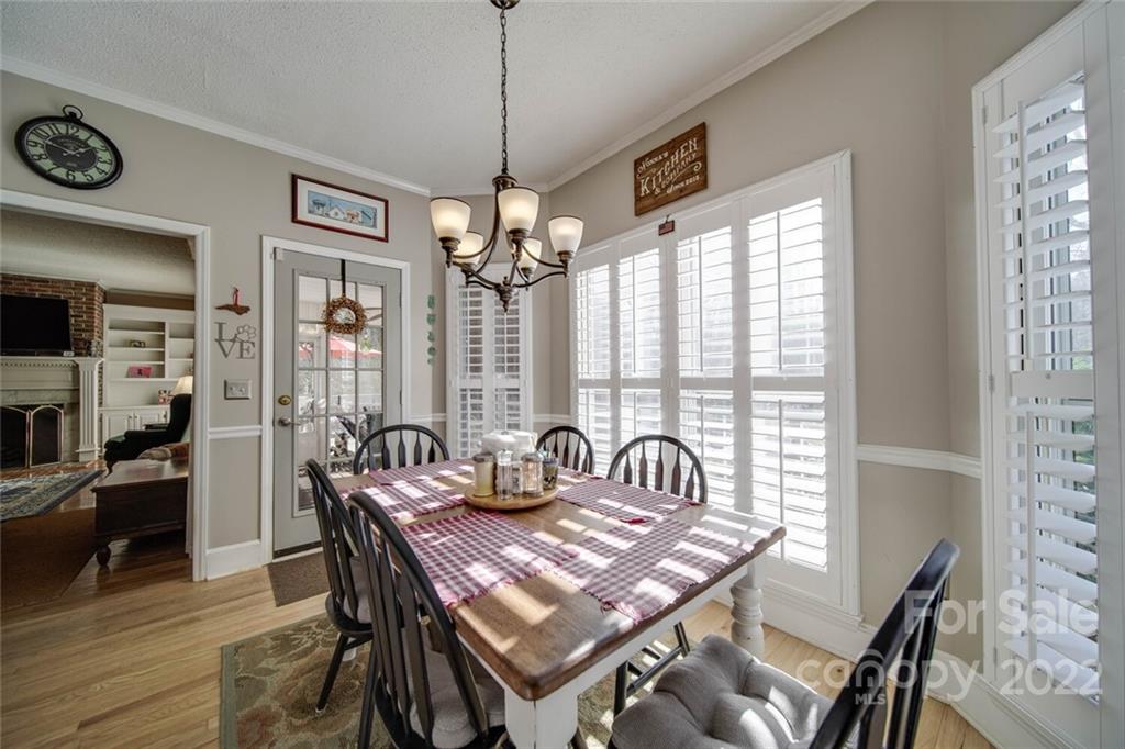 2700 Dutch Road Mount Pleasant, NC 28124 - Photo 18 of 48 a dining room with furniture a chandelier and wooden floor