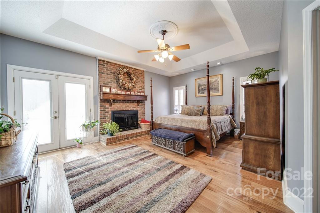 2700 Dutch Road Mount Pleasant, NC 28124 - Photo 20 of 48 a spacious bedroom with a bed and a fireplace