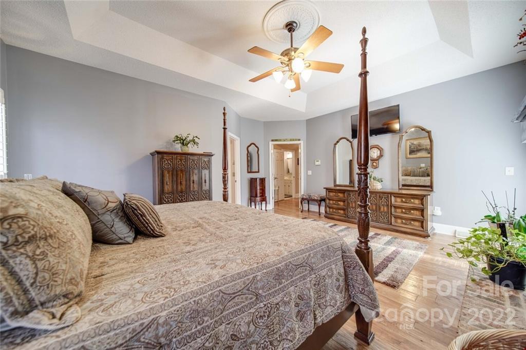 2700 Dutch Road Mount Pleasant, NC 28124 - Photo 22 of 48 a bedroom with a bed and a chandelier