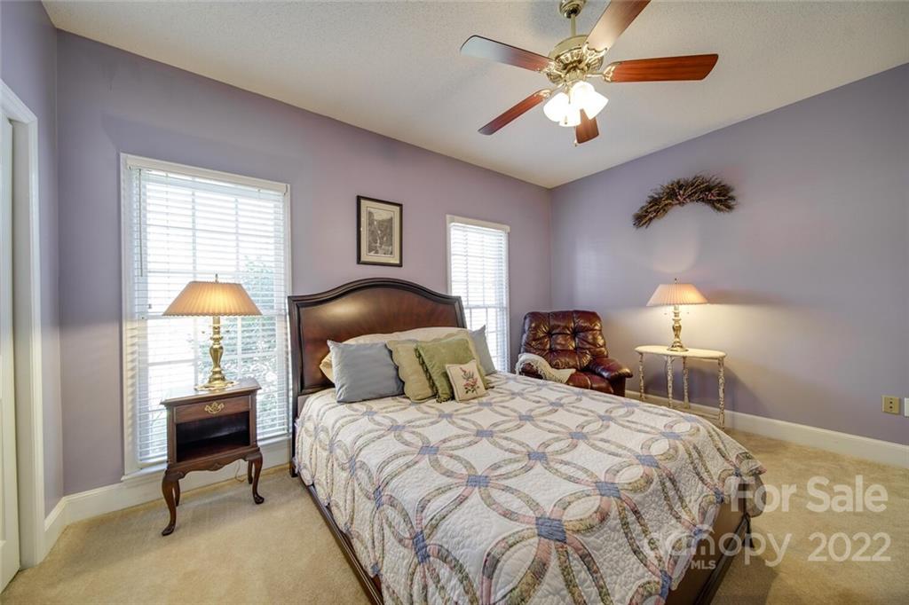 2700 Dutch Road Mount Pleasant, NC 28124 - Photo 29 of 48 a bedroom with a bed and a chandelier