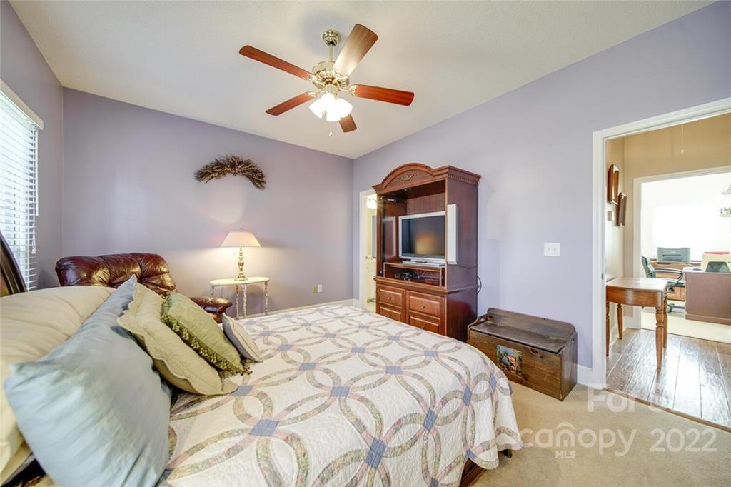 2700 Dutch Road Mount Pleasant, NC 28124 - Photo 30 of 48 a bedroom with a bed and a chandelier