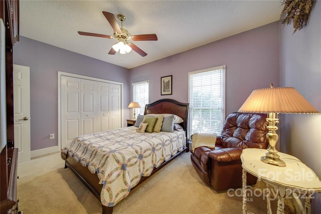 2700 Dutch Road Mount Pleasant, NC 28124 - Photo 31 of 48 a bedroom with a bed and a chandelier