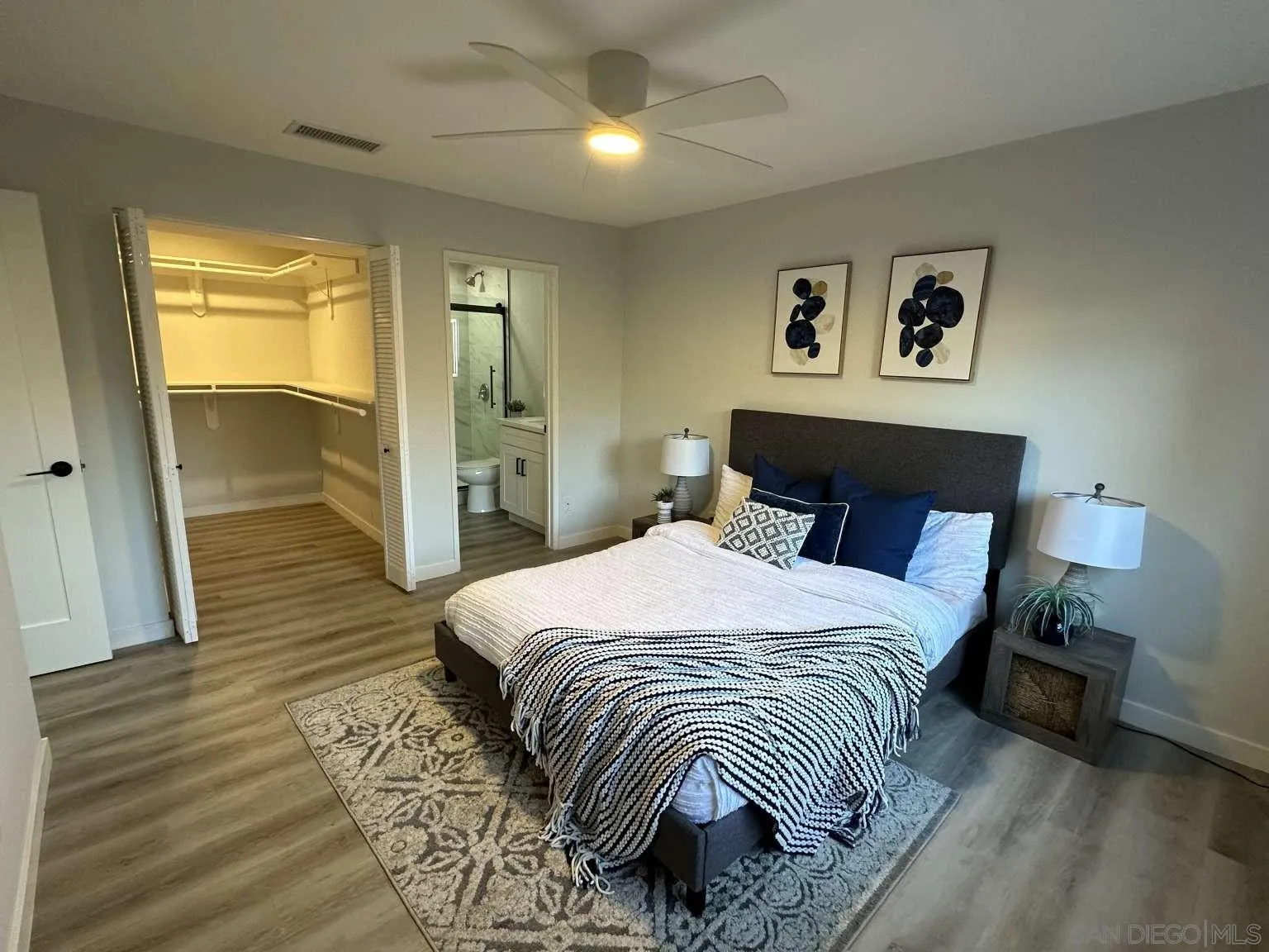 730 Brookstone Road, Unit 104 Chula Vista, CA 91913 - Photo 16 of 22 a bedroom with a bed and a lamp with wooden floor