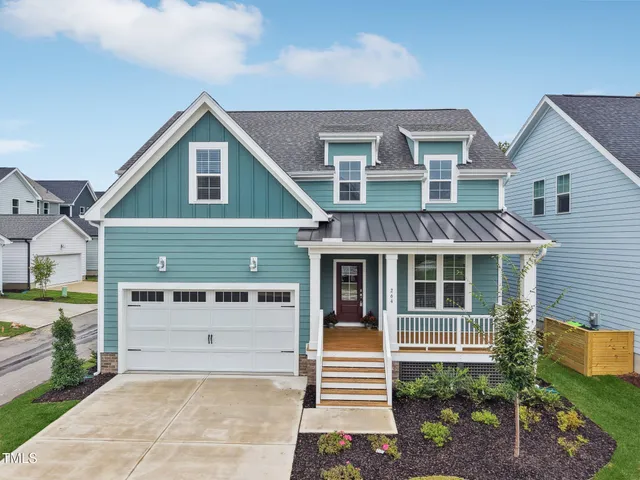 a front view of a house with a garage and balcony