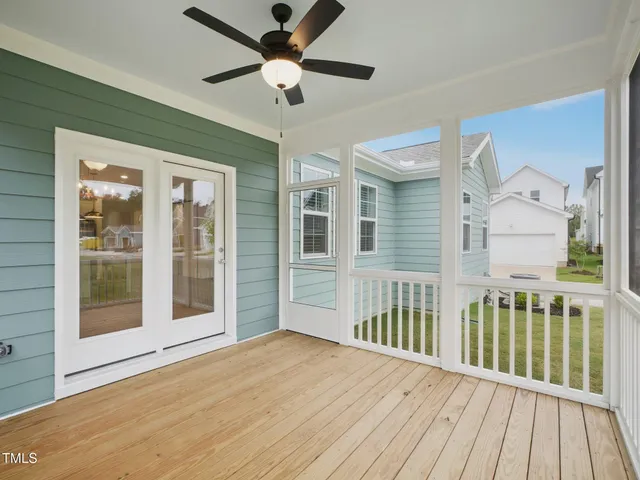an aerial view of residential houses with outdoor space and parking