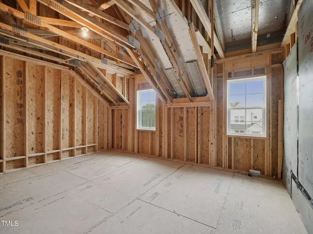 an aerial view of a house with a garden and lake view