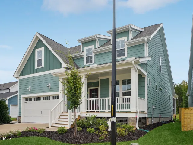 a view of a swimming pool with a lawn chairs under an umbrella