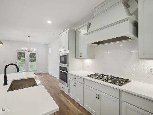 a kitchen with a sink stove and microwave