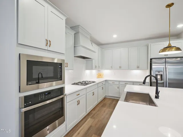 a dining room with furniture potted plants and wooden floor