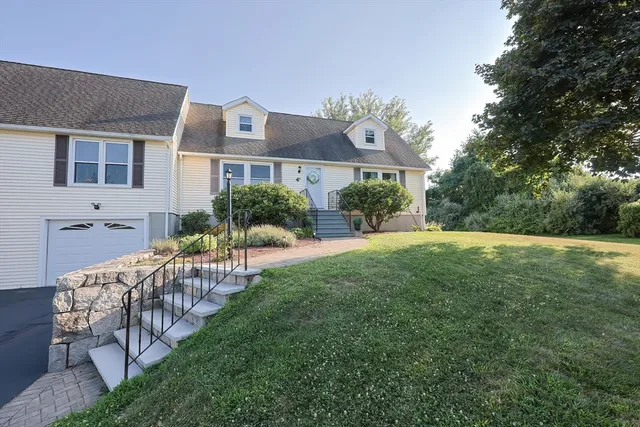 a view of house with backyard and garden