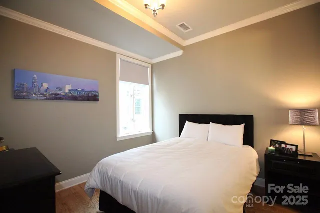 a bedroom with a bed and a closet with window