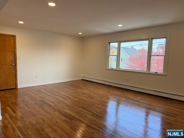 310 Broad Street, Unit 2 Carlstadt, NJ 07072 - Photo 2 of 11 an empty room with wooden floor and windows