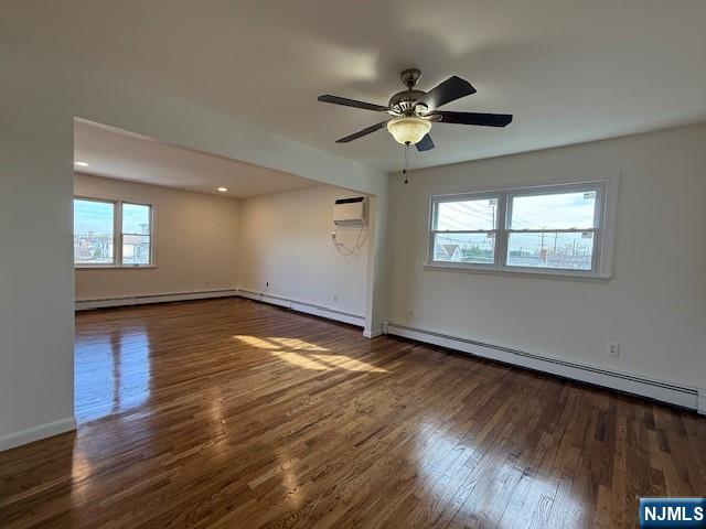 310 Broad Street, Unit 2 Carlstadt, NJ 07072 - Photo 4 of 11 a view of an empty room with wooden floor and a window