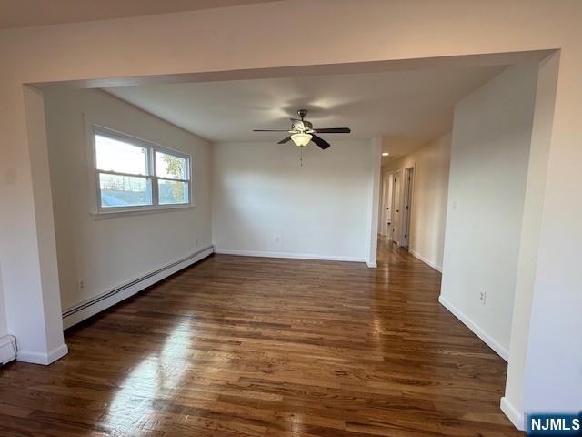 310 Broad Street, Unit 2 Carlstadt, NJ 07072 - Photo 5 of 11 a view of an empty room with wooden floor and a window