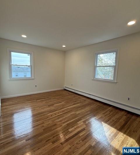 310 Broad Street, Unit 2 Carlstadt, NJ 07072 - Photo 9 of 11 an empty room with wooden floor and windows