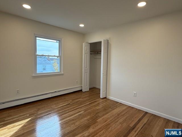 310 Broad Street, Unit 2 Carlstadt, NJ 07072 - Photo 10 of 11 an empty room with wooden floor and windows
