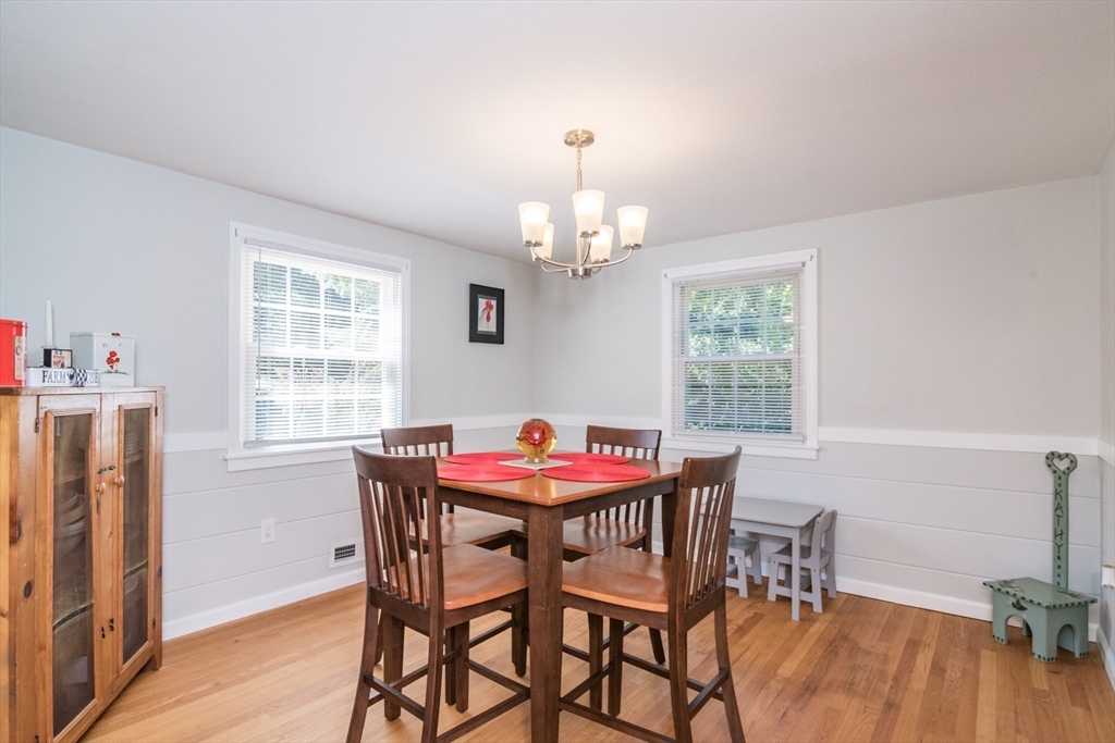 567 Maple Road Longmeadow, MA 01106 - Photo 12 of 41 a dining room with furniture a chandelier and wooden floor