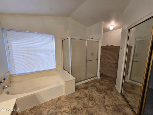 a bathroom with a bathtub and a shower