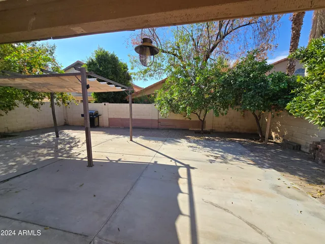 a backyard of a house with table and chairs