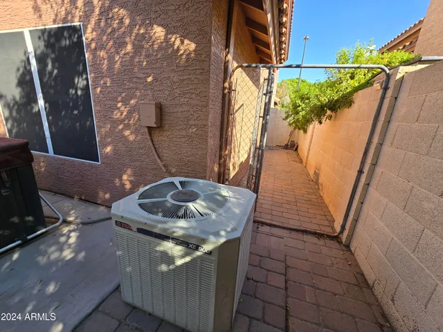 a backyard of a house with table and chairs