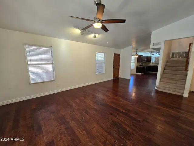a view of livingroom with hardwood floor and a ceiling fan