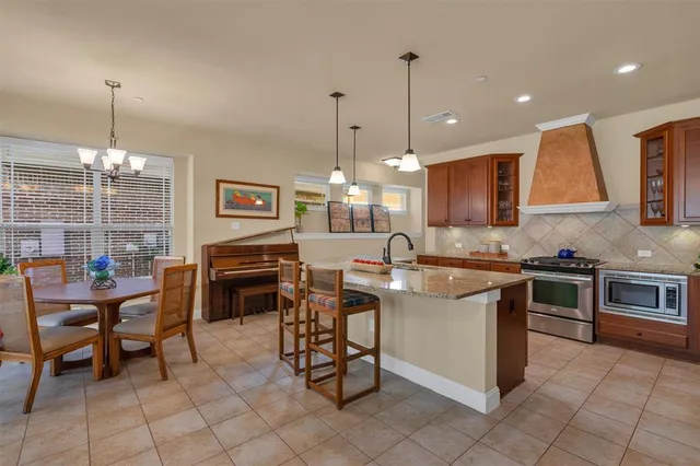 a kitchen with stainless steel appliances granite countertop a sink and a wooden floors