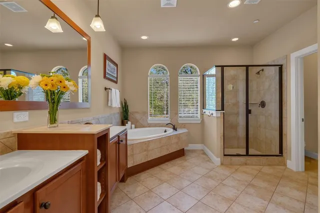 a bedroom with bed and a chandelier