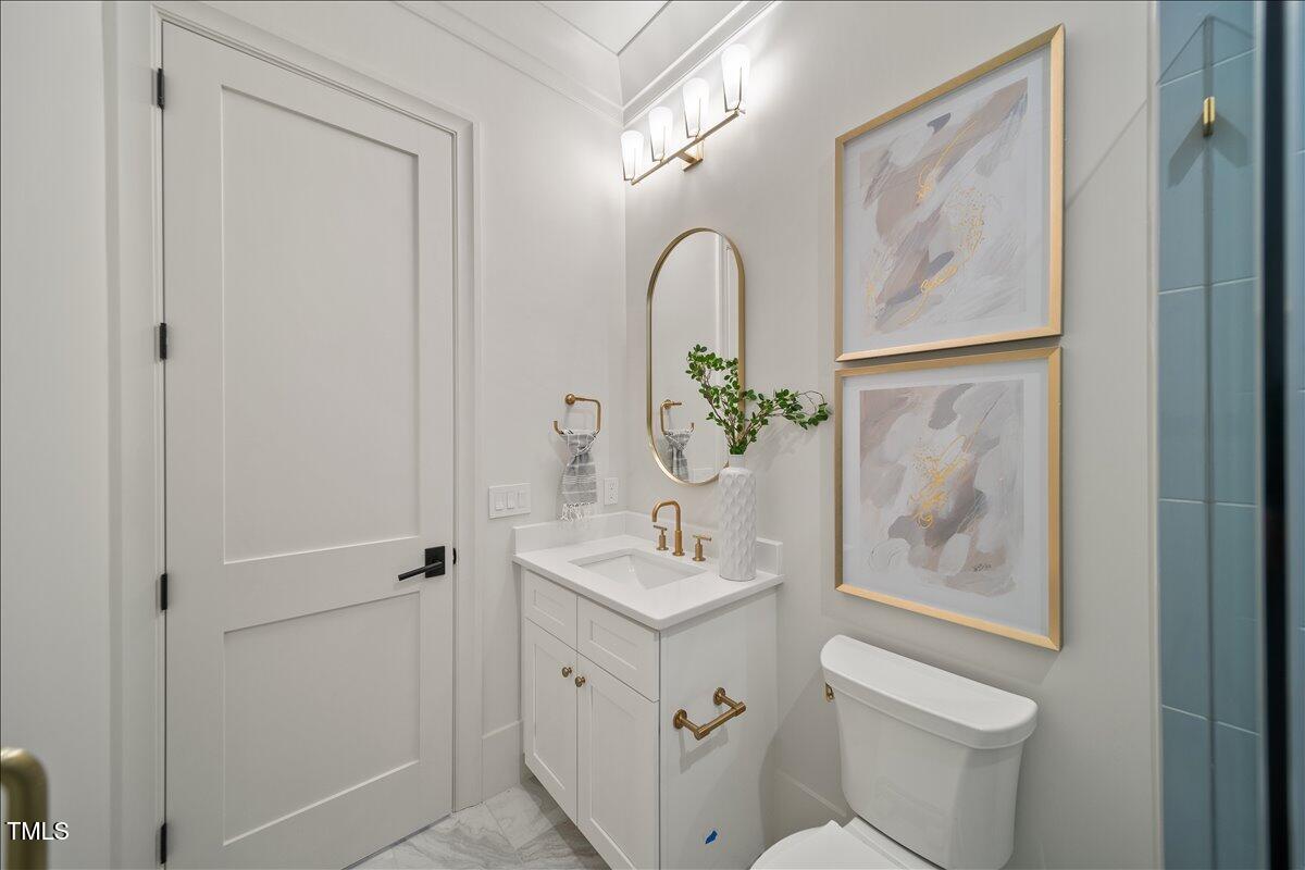 7516 Grist Mill Road Raleigh, NC 27615 - Photo 33 of 83 a bathroom with a sink and mirror with toilet