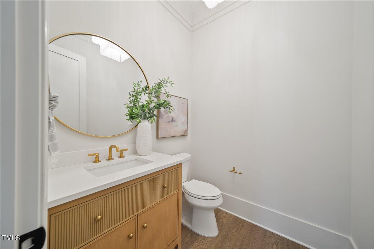 7516 Grist Mill Road Raleigh, NC 27615 - Photo 35 of 83 a bathroom with a toilet sink and mirror
