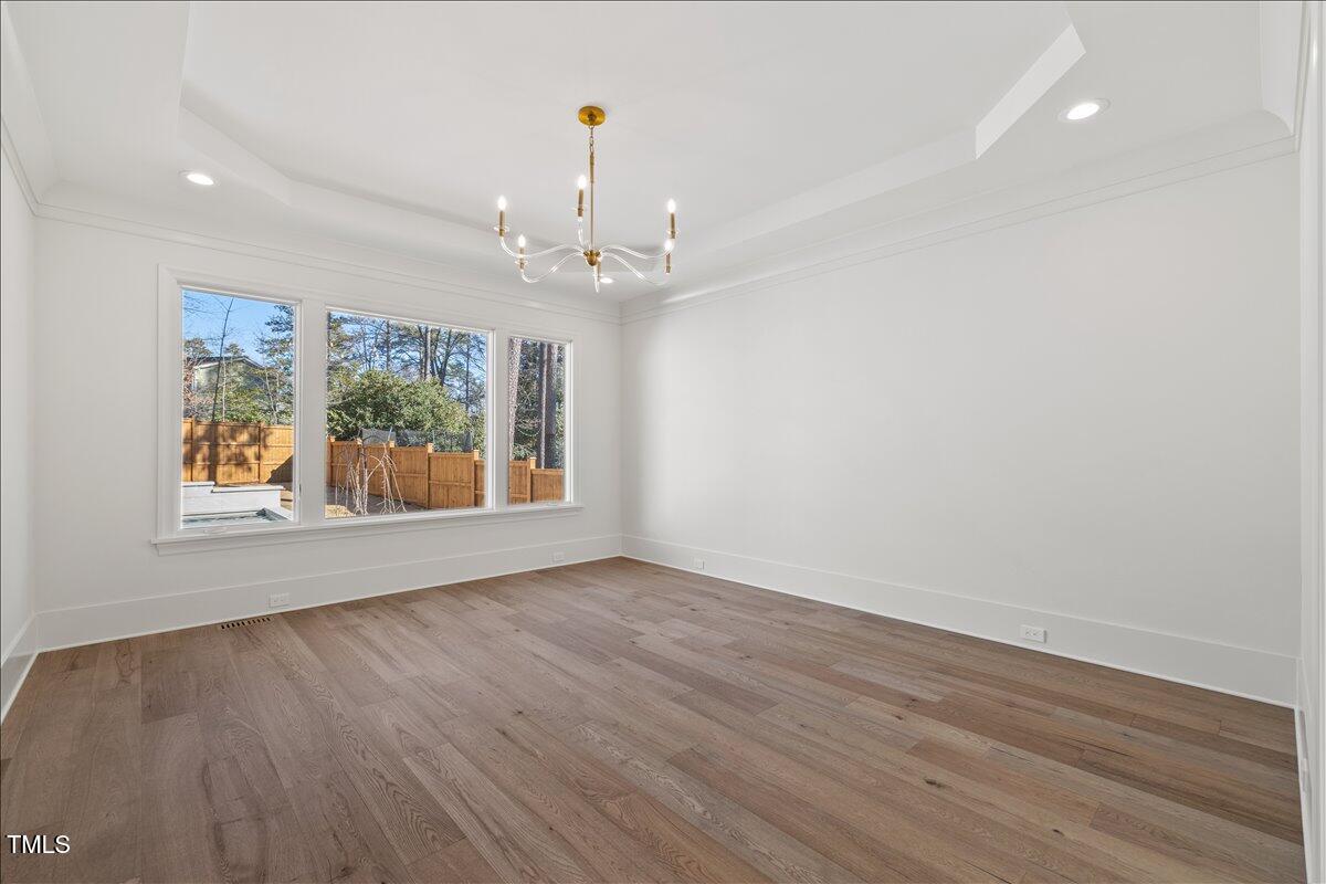 7516 Grist Mill Road Raleigh, NC 27615 - Photo 37 of 83 a view of an empty room with wooden floor and a window