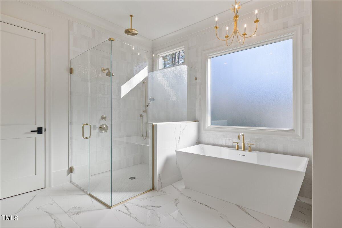 7516 Grist Mill Road Raleigh, NC 27615 - Photo 41 of 83 a bathroom with a bathtub shower sink and mirror