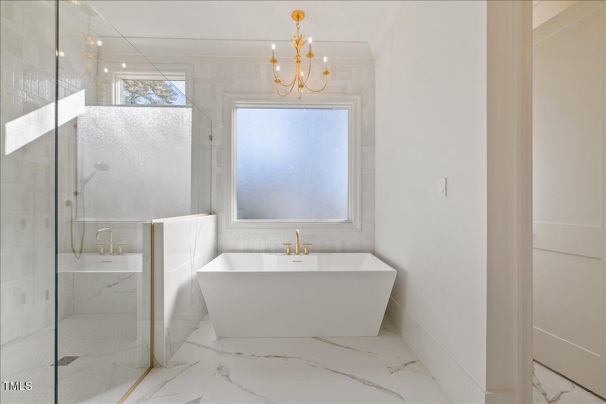 7516 Grist Mill Road Raleigh, NC 27615 - Photo 42 of 83 a spacious bathroom with a bathtub and shower