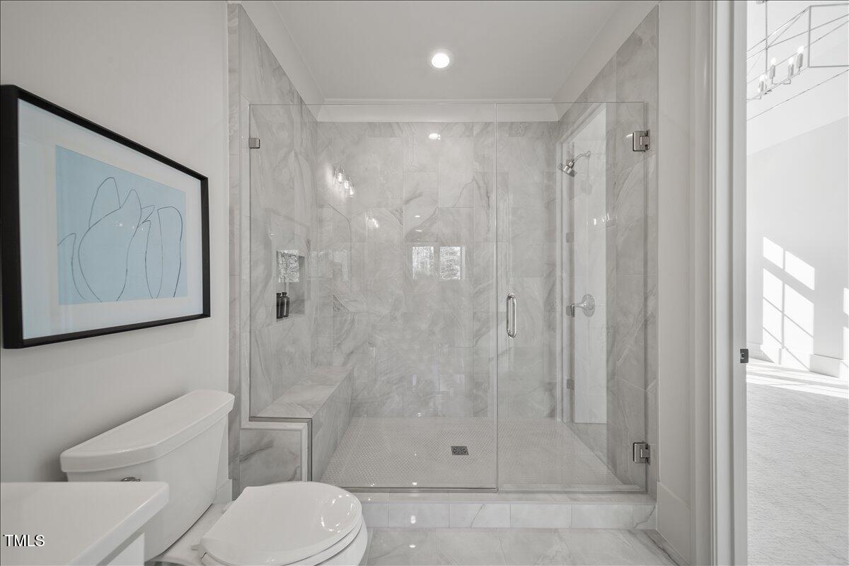 7516 Grist Mill Road Raleigh, NC 27615 - Photo 51 of 83 a bathroom with a shower a toilet and sink