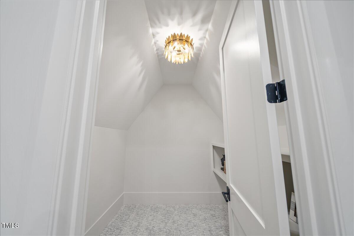 7516 Grist Mill Road Raleigh, NC 27615 - Photo 60 of 83 a bathroom with a light fixture a mirror and a shower