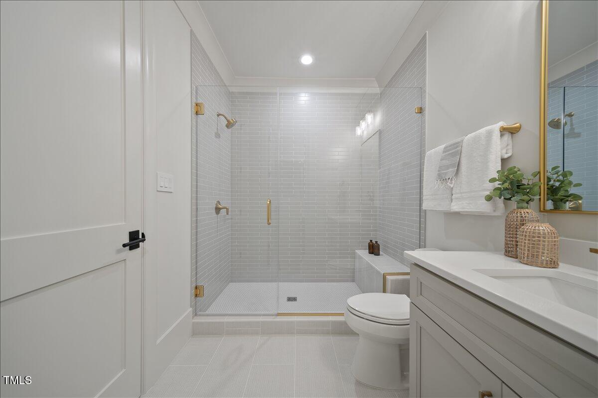 7516 Grist Mill Road Raleigh, NC 27615 - Photo 67 of 83 a bathroom with a sink a toilet and shower