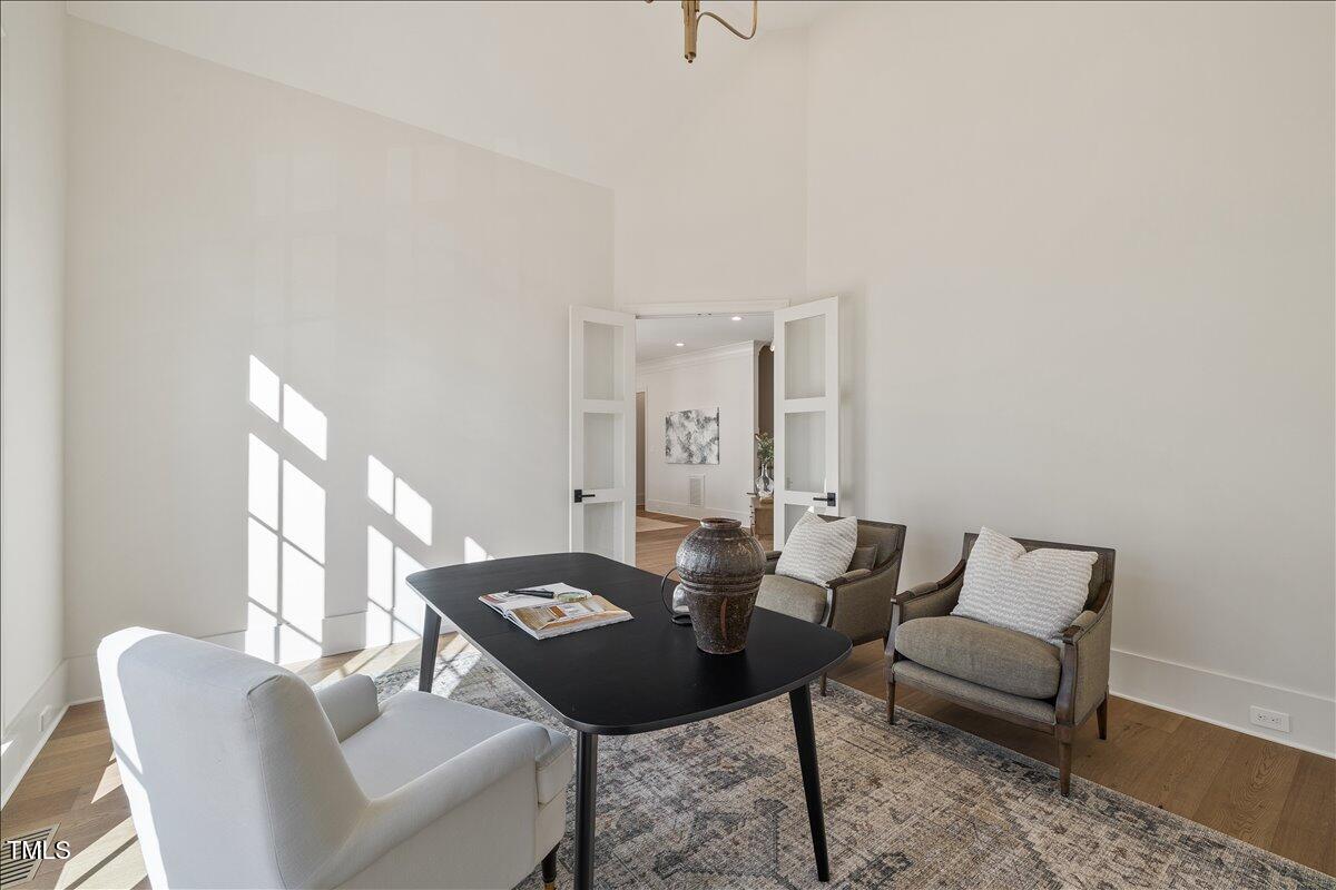 7516 Grist Mill Road Raleigh, NC 27615 - Photo 7 of 83 a view of a dining room with furniture and wooden floor