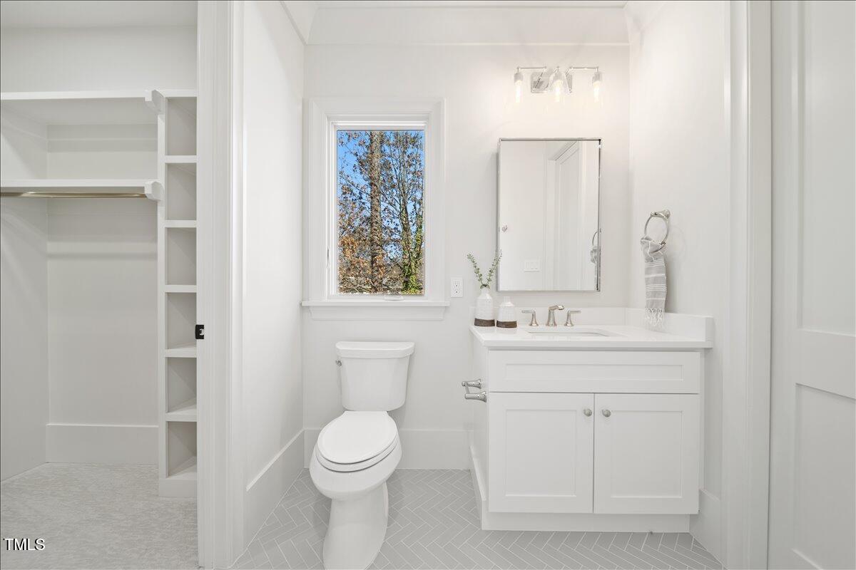 7516 Grist Mill Road Raleigh, NC 27615 - Photo 71 of 83 a bathroom with a toilet sink and mirror
