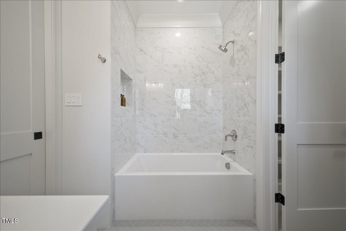 7516 Grist Mill Road Raleigh, NC 27615 - Photo 72 of 83 a bathroom with a bathtub and shower