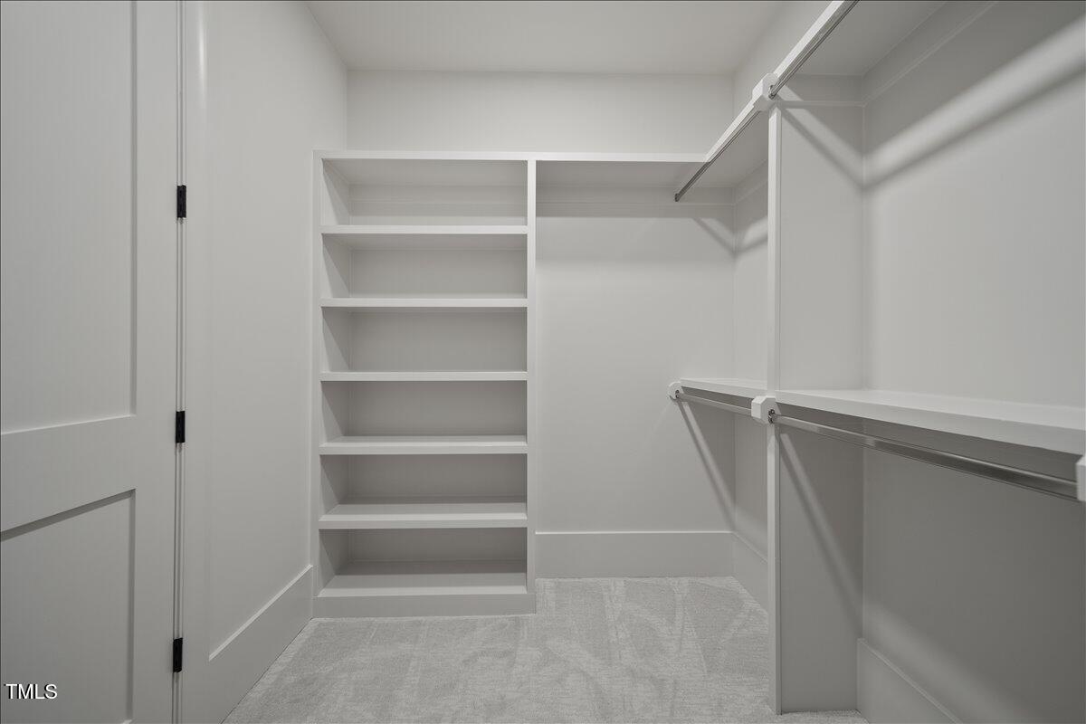 7516 Grist Mill Road Raleigh, NC 27615 - Photo 74 of 83 a view of walk in closet with empty racks