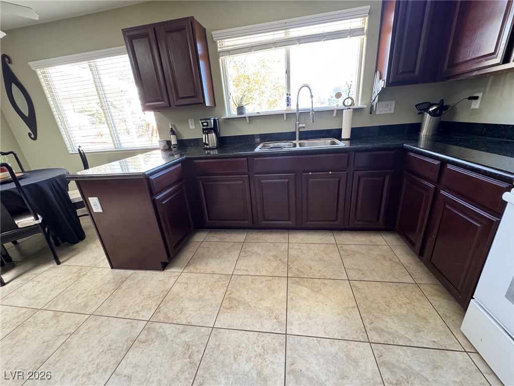504 I Avenue Boulder City, NV 89005 - Photo 18 of 60 Kitchen featuring a peninsula, light tile patterned floors, plenty of natural light, and white range