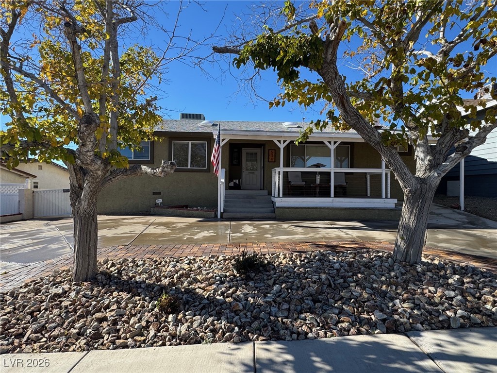 504 I Avenue Boulder City, NV 89005 - Photo 3 of 60 Ranch-style house featuring a porch, concrete driveway, and crawl space