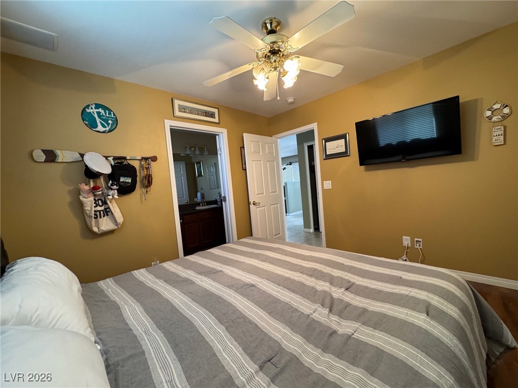 504 I Avenue Boulder City, NV 89005 - Photo 33 of 60 Bedroom featuring ceiling fan and ensuite bath
