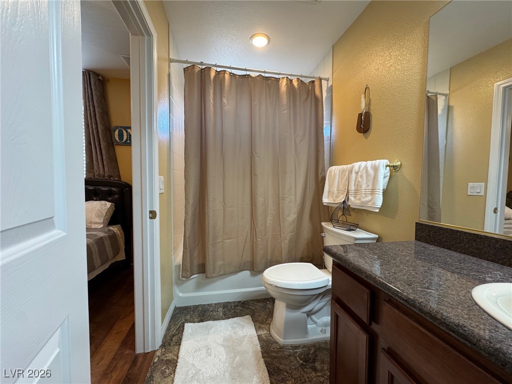 504 I Avenue Boulder City, NV 89005 - Photo 37 of 60 Full bathroom with vanity, connected bathroom, shower / bath combo, and a textured wall