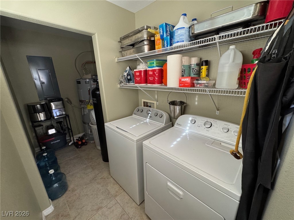 504 I Avenue Boulder City, NV 89005 - Photo 40 of 60 Washroom featuring electric panel, washing machine and dryer, light tile patterned floors, and gas water heater