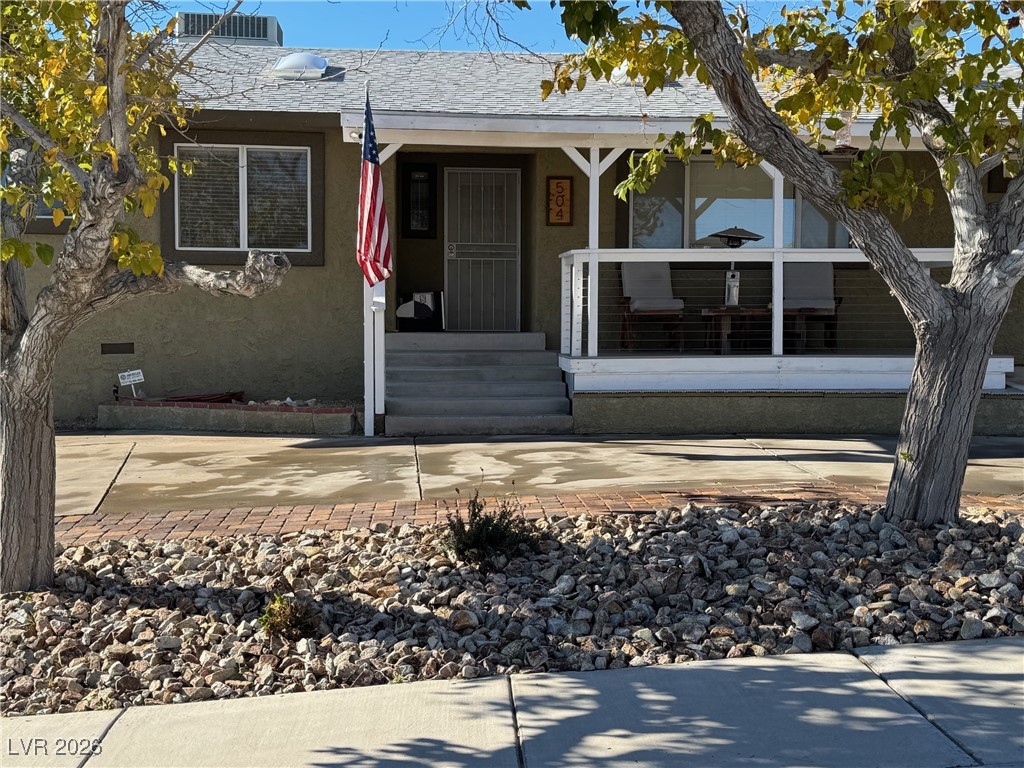 504 I Avenue Boulder City, NV 89005 - Photo 5 of 60 View of front facade with covered porch, stucco siding, and crawl space