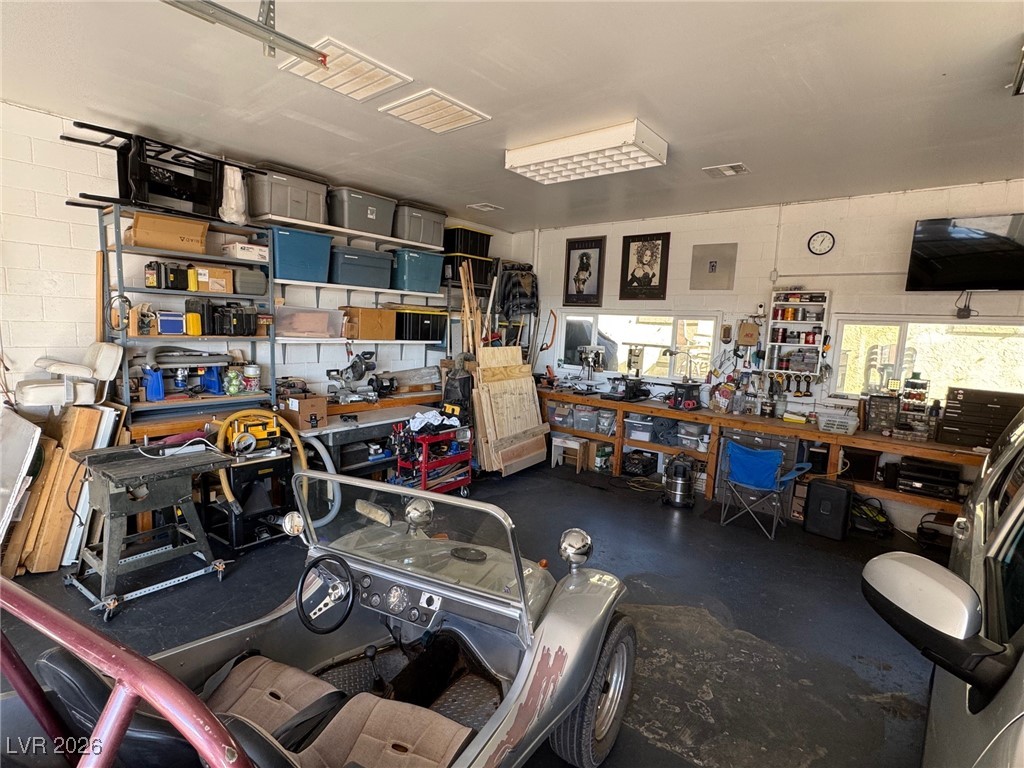 504 I Avenue Boulder City, NV 89005 - Photo 57 of 60 Garage with concrete block wall and a workshop area